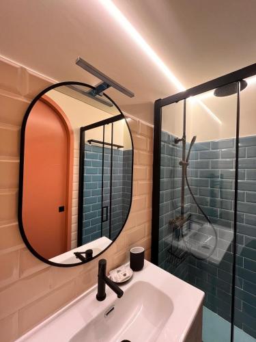 a bathroom with a sink and a mirror at Bragança Apartments in Bragança