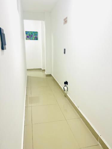 a hallway with a cat sitting on the floor at Laurel plaza 46 in Montería
