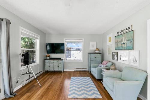 a living room with a couch and a tv at Greenwood Beach House - beach access and a variety of outdoor activities. in Mears