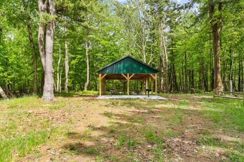 a gazebo in the middle of a forest at Greenwood Beach House - beach access and a variety of outdoor activities. in Mears