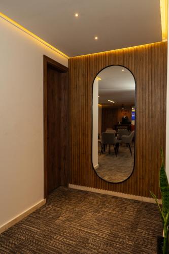 a hallway with a mirror and a dining room at Hotel ByHours Las Américas in Bogotá
