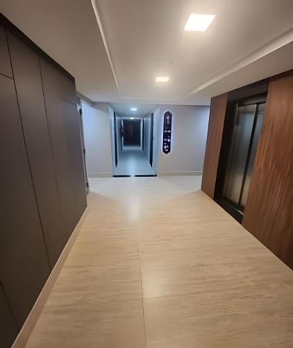 an empty corridor in an office building with a hallway at Get By Side in João Pessoa