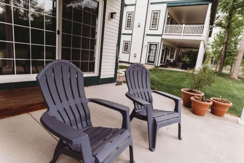 two chairs sitting on a patio in front of a house at Picturesque Condo perfect for Golf, Families, Pools and Lake vacation in Bellaire