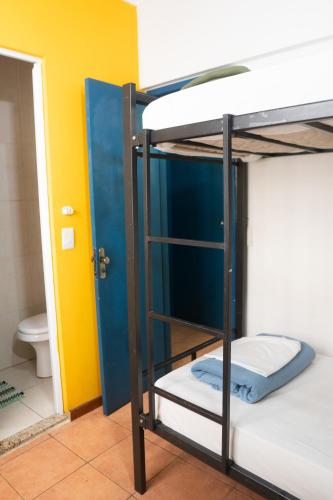a group of bunk beds in a room with a toilet at POA Eco Hostel in Porto Alegre