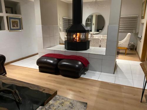 a living room with a fireplace and a leather ottoman at Spacious Living, Suitable for all Groups in Johannesburg