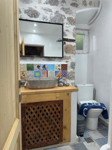 a bathroom with a sink and a mirror at Polina's Apartments in Hydra