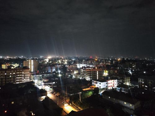 a view of a city at night with lights at Perfect Hideaway in Rungiri