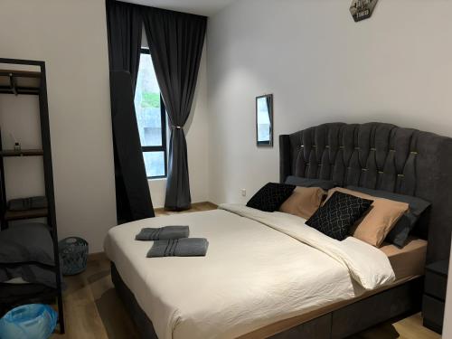 a bedroom with a large bed with a black headboard at Serene Terrace House 2-12pax &Sunrise View in Brinchang