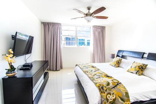 a bedroom with a bed and a television in it at Ocean Reserve 818 in Miami Beach