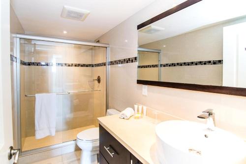 a bathroom with a shower and a sink and a toilet at Ocean Reserve 818 in Miami Beach