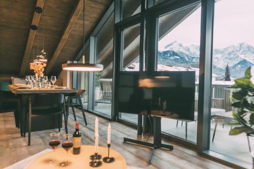 a dining room with a table with wine glasses at LIVALPIN Hideaway in Garmisch-Partenkirchen