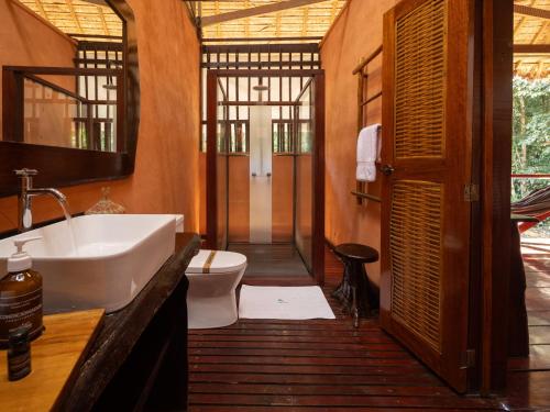 a bathroom with a sink and a toilet at Refugio Amazonas Lodge in Tambopata
