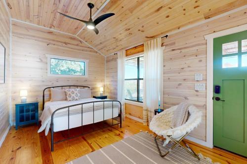 a bedroom with a bed and a green door at Green Acres in Hye