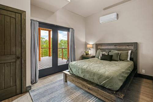 a bedroom with a bed and a door to a balcony at Peaceful Vista in Sevierville