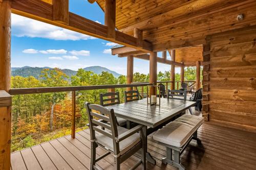 a wooden deck with a table and chairs on it at Peaceful Vista in Sevierville