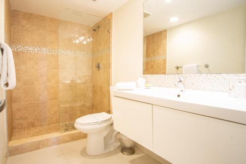 a bathroom with a toilet and a sink and a shower at Ocean Reserve 927 in Miami Beach