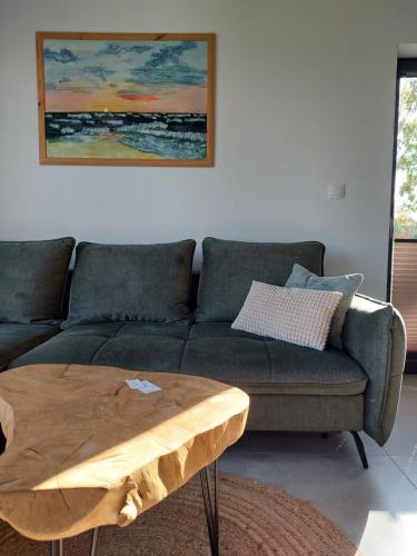 a living room with a couch and a wooden coffee table at Domki Miłe Chwile in Lubiatowo