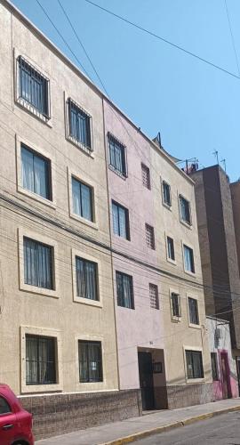 a large brick building on the side of a street at Acogedor departamento cerca del metro guerrero e hidalgo in Mexico City