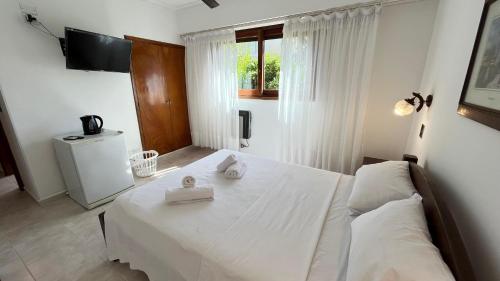 a bedroom with a bed with two white towels on it at Hotel Olimpia in Ostende