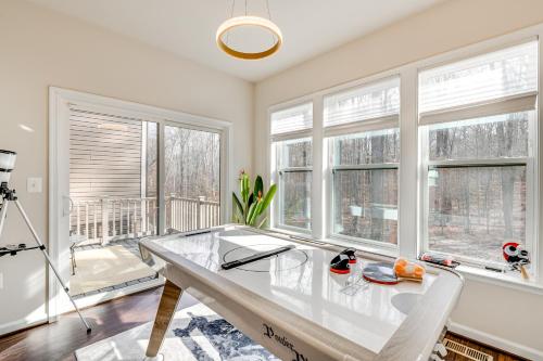 a dining room with a glass table and windows at 19 Mi to Baltimore Townhome in Maryland City in Maryland City