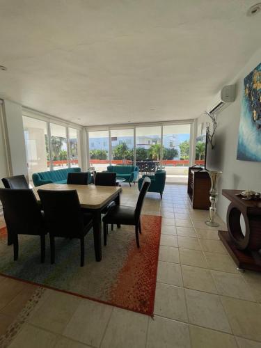a living room with a table and chairs and a couch at Residencias Reef in Cozumel
