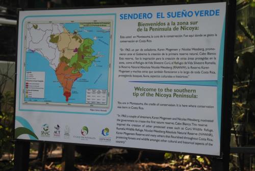 a sign for the preserve with a map at El Pargo Feliz in Montezuma