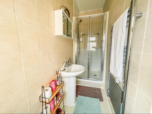a small bathroom with a sink and a shower at 1 bed cozy apartment central London in London
