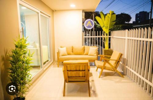 a living room with a couch and chairs on a balcony at Abel Boutique House in Cartagena de Indias