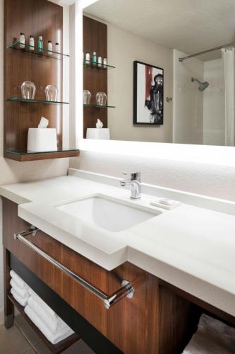 a bathroom with a white sink and a mirror at Delta Hotels by Marriott Minneapolis Northeast in Minneapolis