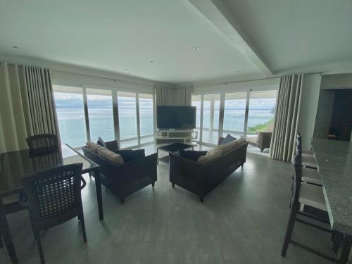 a living room with a view of the ocean at Noor Villa - Luxury 3 Bed, 2 Bath Apartment with Stunning Panoramic Sea View, Private Beach in Pinamihagan