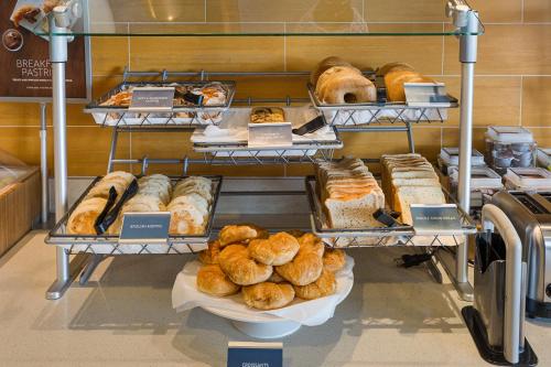 a bakery with various types of bread and pastries at SpringHill Suites by Marriott Houston Rosenberg in Rosenberg