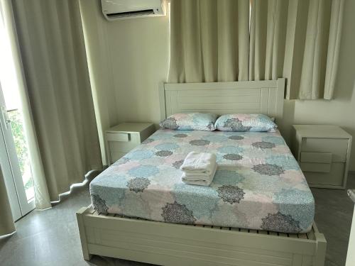 a bedroom with a bed with a quilt and two pillows at Amal Villa - Luxury 2 Bed, 2 Bath Apartment with Panoramic Ocean Views, Peaceful, Private Beach in San Jose