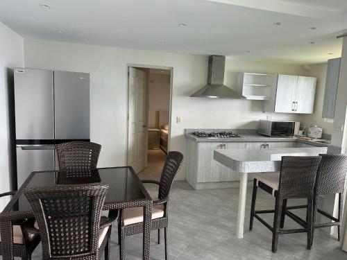 a kitchen with a table and chairs in a kitchen at Amal Villa - Luxury 2 Bed, 2 Bath Apartment with Panoramic Ocean Views, Peaceful, Private Beach in San Jose
