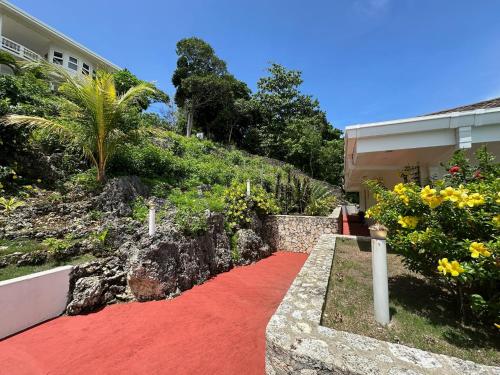 a red carpet in front of a house at Amal Villa - Luxury 2 Bed, 2 Bath Apartment with Panoramic Ocean Views, Peaceful, Private Beach in San Jose