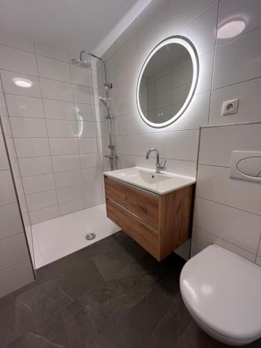 a bathroom with a sink and a shower and a toilet at Ferienhaus Sarah in Schruns
