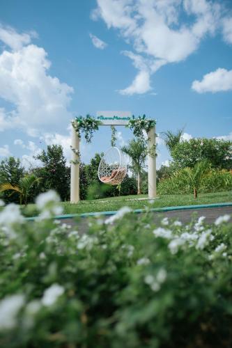 a garden with a swing in the middle of a road at Theron Leisure Park & Residences in Kalungu