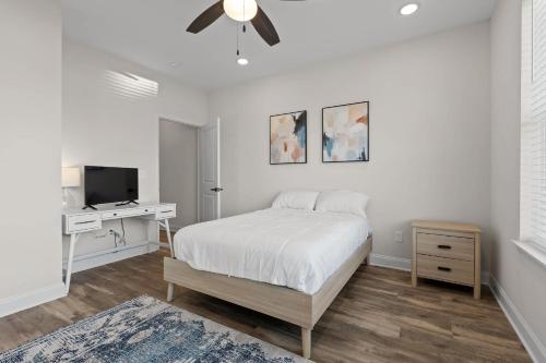 a bedroom with a bed and a desk with a television at Chic 2BR at The Poplin - Southside Chattanooga in Chattanooga