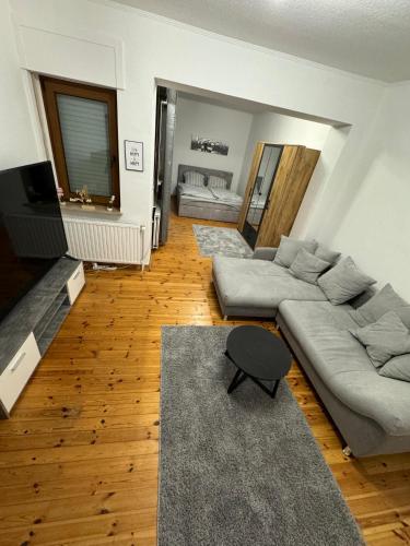 a living room with a couch and a table at Doppelzimmer und Garten in Haus in Jülich