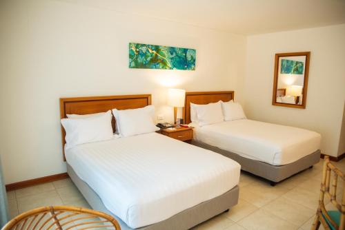 Postel nebo postele na pokoji v ubytování Estelar Santamar Hotel & Centro De Convenciones