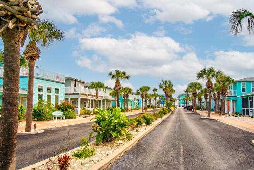 an empty street in a town with palm trees at Friday Life in Port Aransas