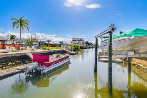 a boat is docked at a dock in a river at Spacious Canalfront Home with Pool about half Mi to Beach in Hudson