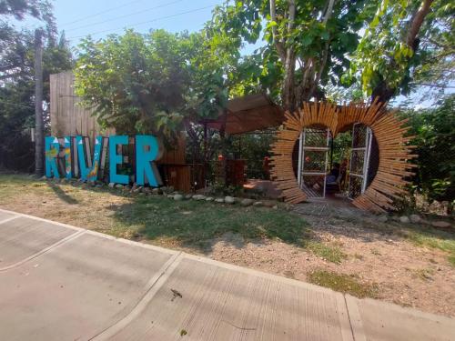 a playground with a sign that reads river at River Glamping Melgar in Melgar
