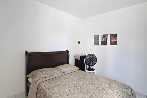a white bedroom with a bed and a fan at AMPLO 3 quartos no Bessa, vaga dupla de garagem in Nossa Senhora do Livramento