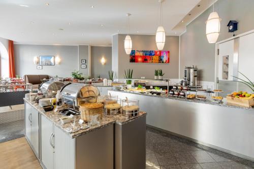 a buffet line in a restaurant with food at Garner Hotel Berlin - Checkpoint Charlie by IHG in Berlin