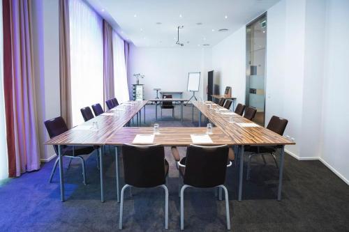 a large conference room with a long table and chairs at Garner Hotel Berlin - Checkpoint Charlie by IHG in Berlin