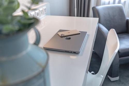 a laptop on a white desk with a chair at Garner Hotel Berlin - Checkpoint Charlie by IHG in Berlin