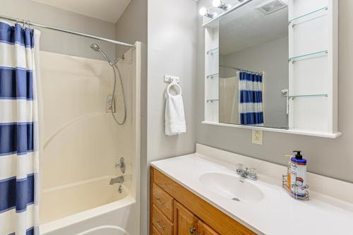 a bathroom with a sink and a shower and a mirror at Kentucky Lake Retreat Near Marina and Launch! in Faxon