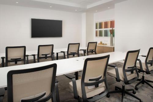 a conference room with a large white table and chairs at Element Jacksonville Beach in Jacksonville Beach