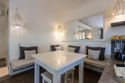 a living room with a white table and a couch at Casa Kokoro in Pipa