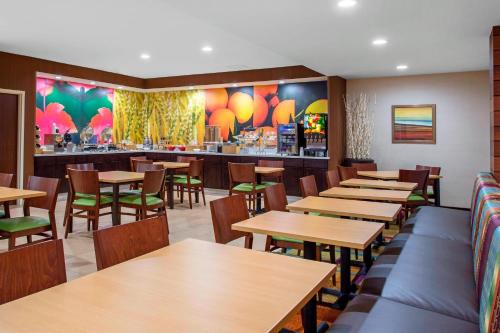 a restaurant with wooden tables and chairs and a bar at Fairfield Inn & Suites by Marriott Santa Fe in Santa Fe